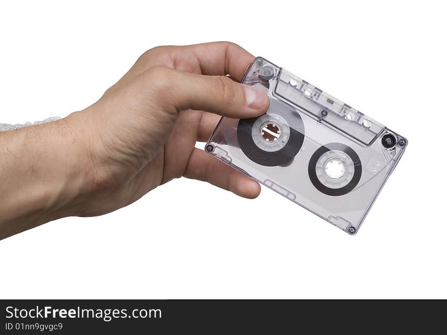 Man hand with an old audio cassette isolated on white background