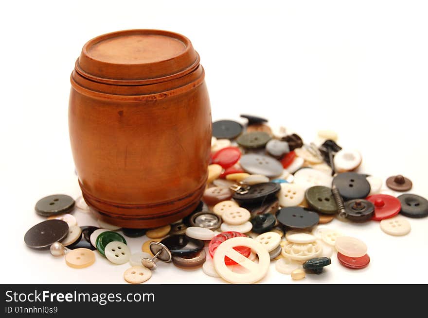 Wooden keg on a  background from various buttons