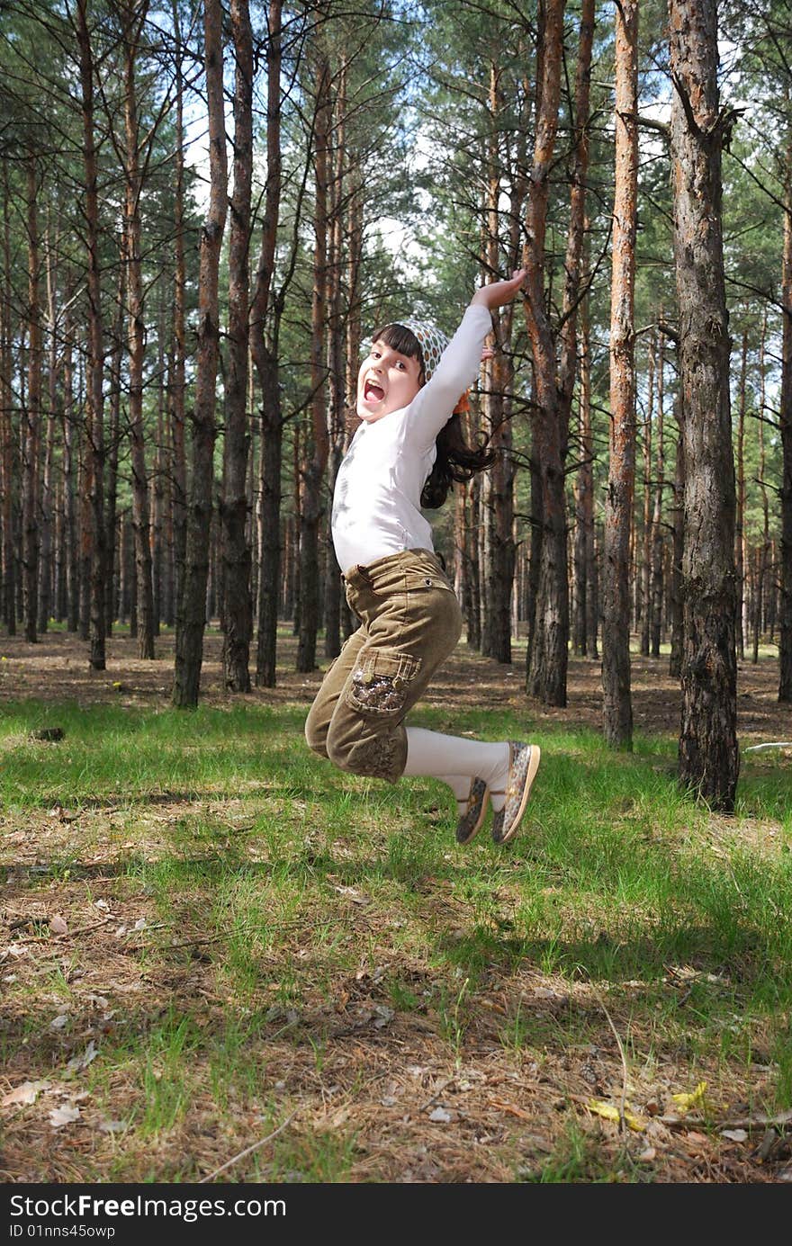 Jumping child over spring forest