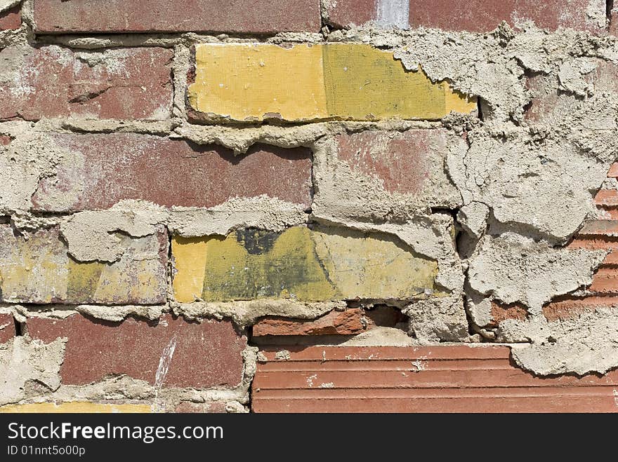 Old brick wall with different bricks and lots of grout