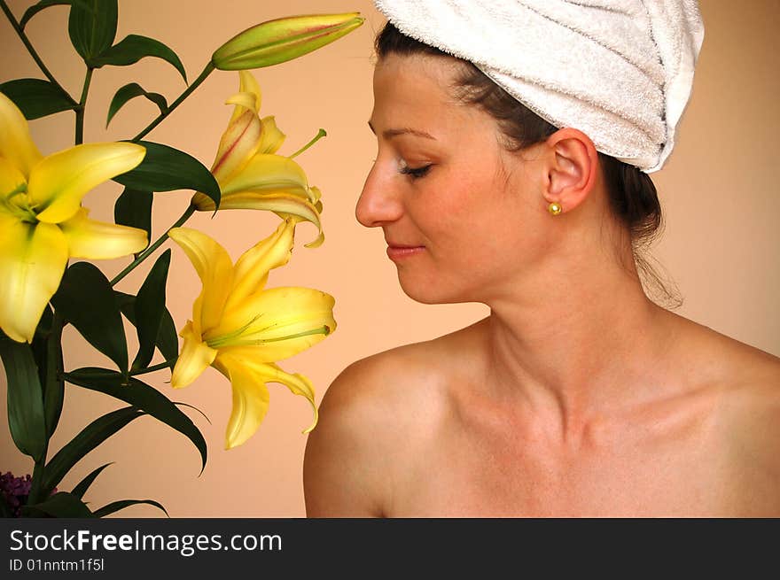 Beautiful woman looking at yellow lilies. Beautiful woman looking at yellow lilies