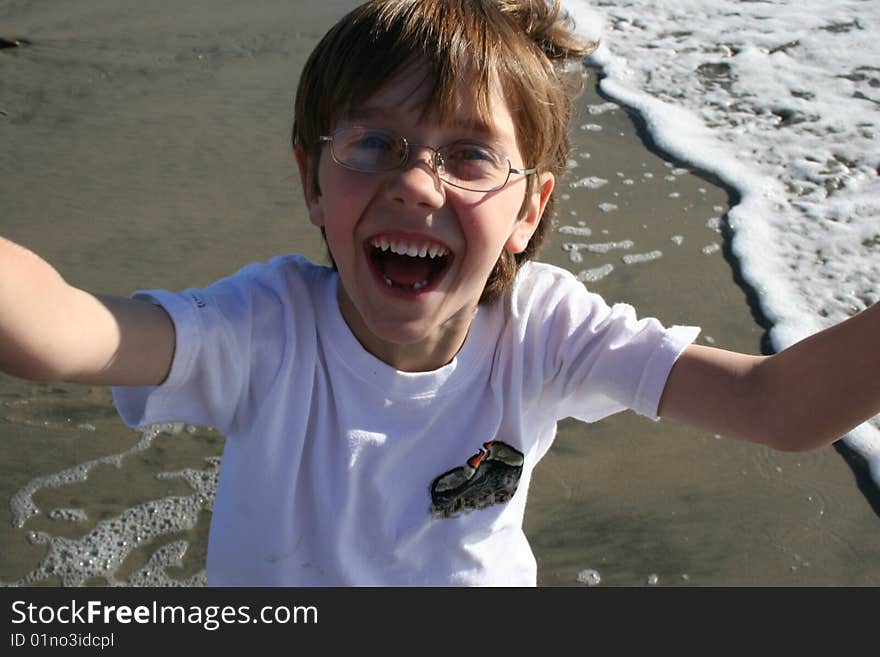 Boy at beach reaching up at you. Boy at beach reaching up at you