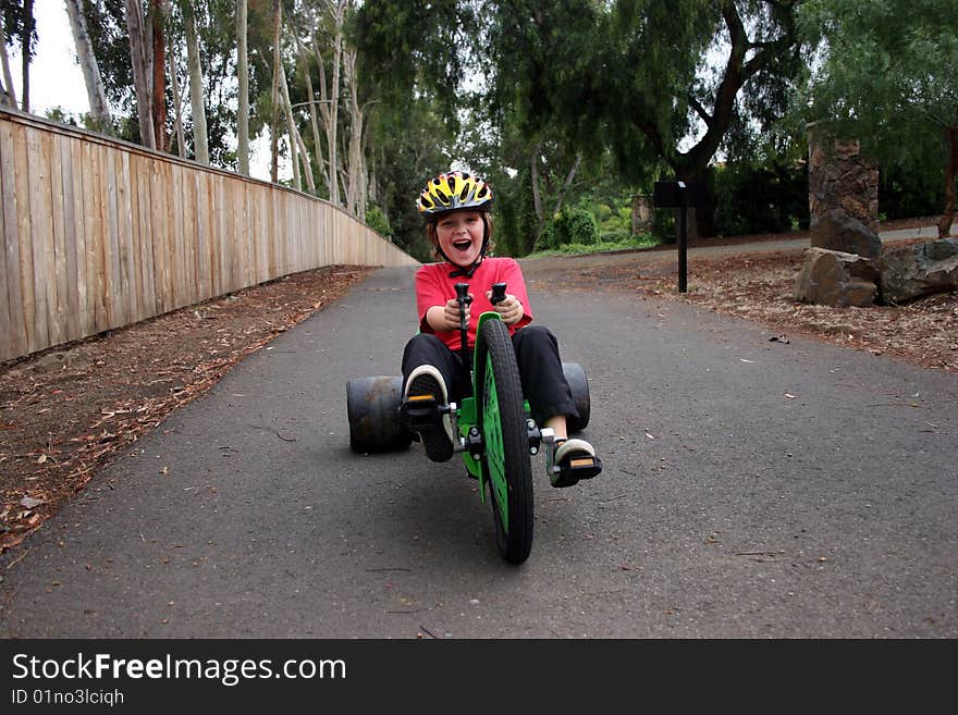 Boy racing in his bike towards you. Boy racing in his bike towards you