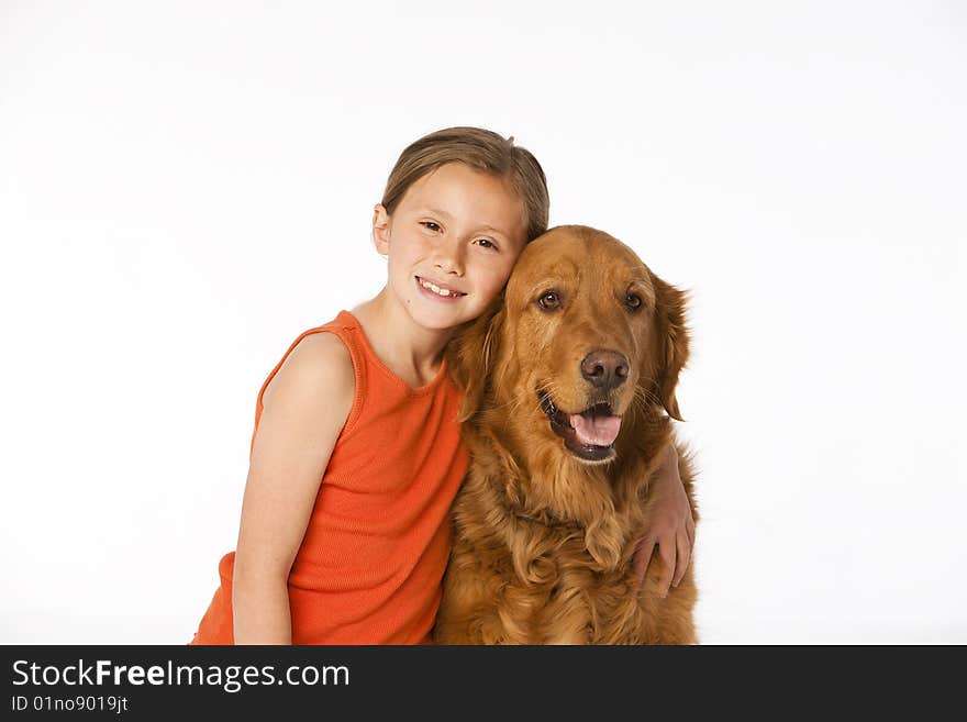 Young girl with golden retriever on white.