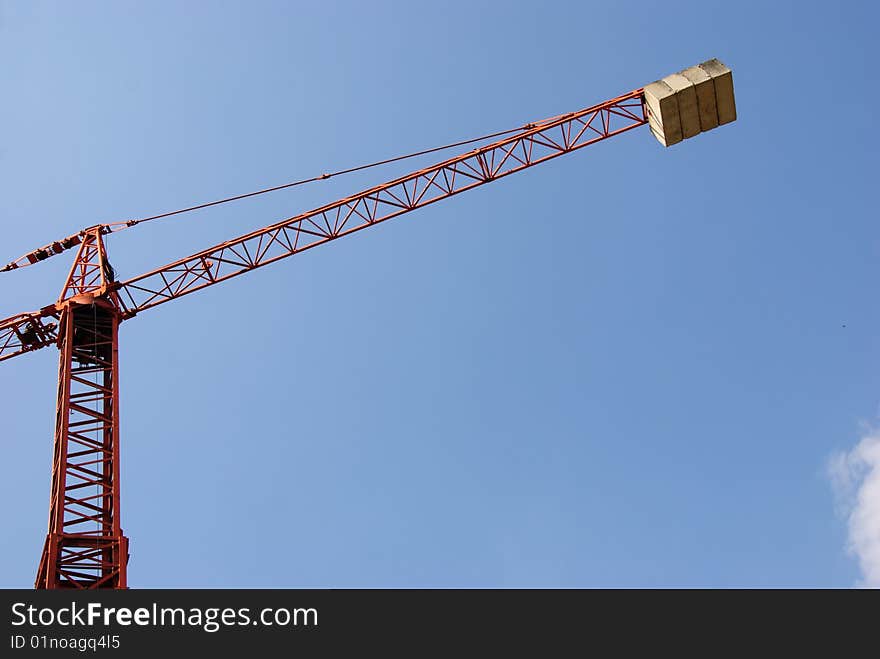 Tall crane against blue sky