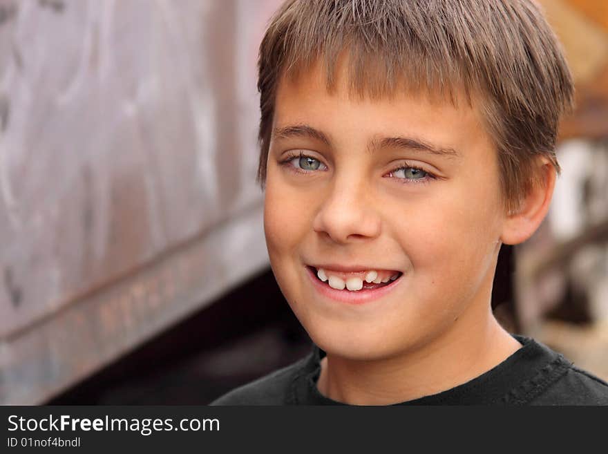 Boy smiling against colorful background brown tones