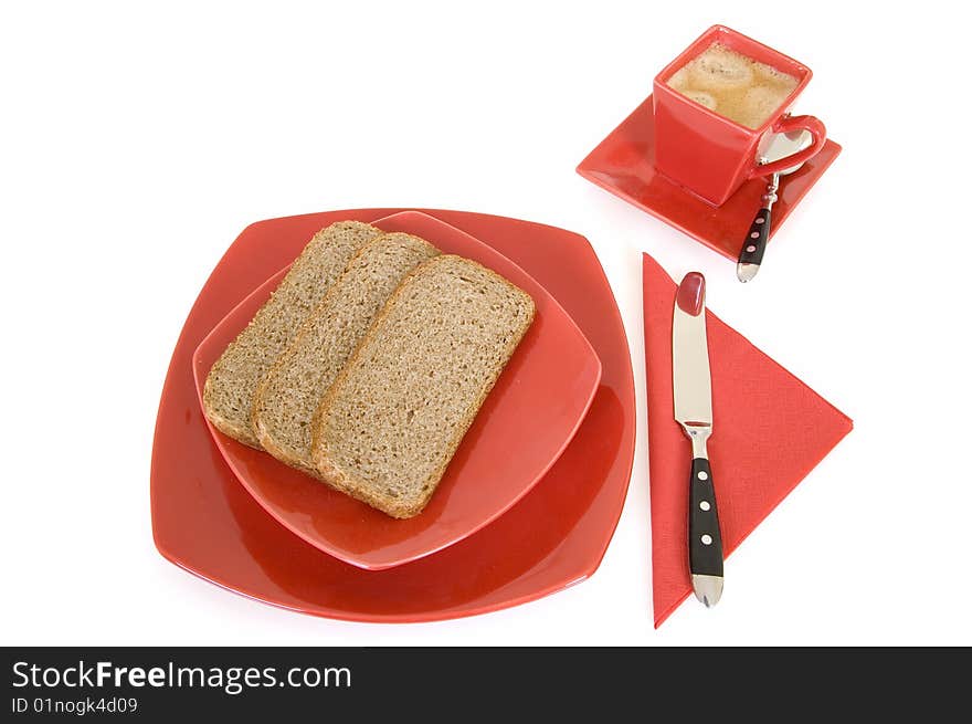 Breakfast arrangement with bread and coffee cup isolated on white background