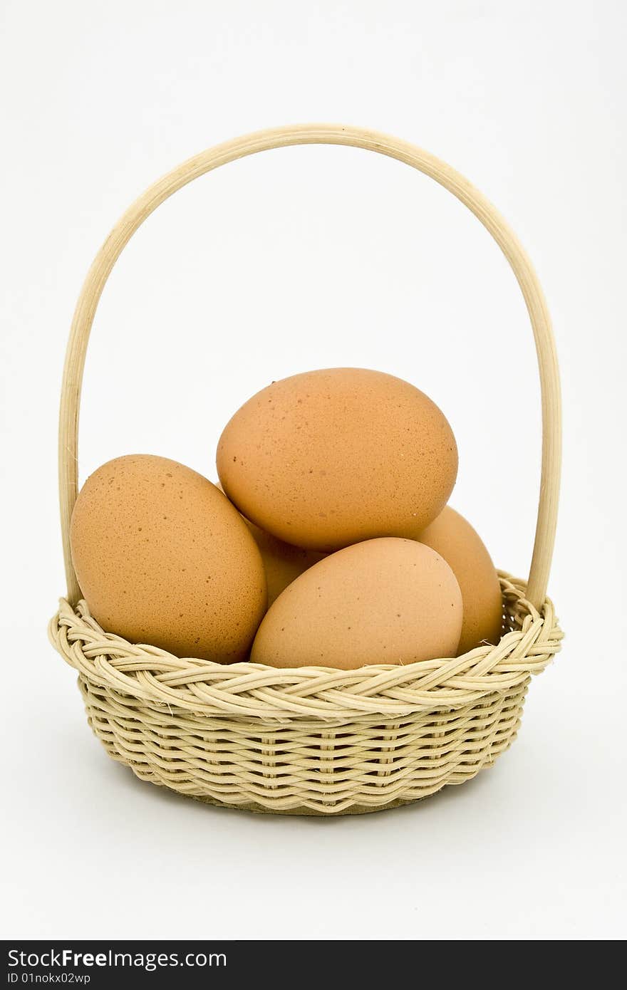 Eggs in a basket on a white background. Eggs in a basket on a white background