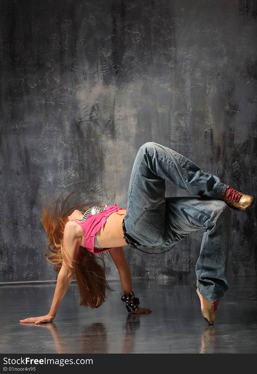 Modern style dancer posing on studio background. Modern style dancer posing on studio background