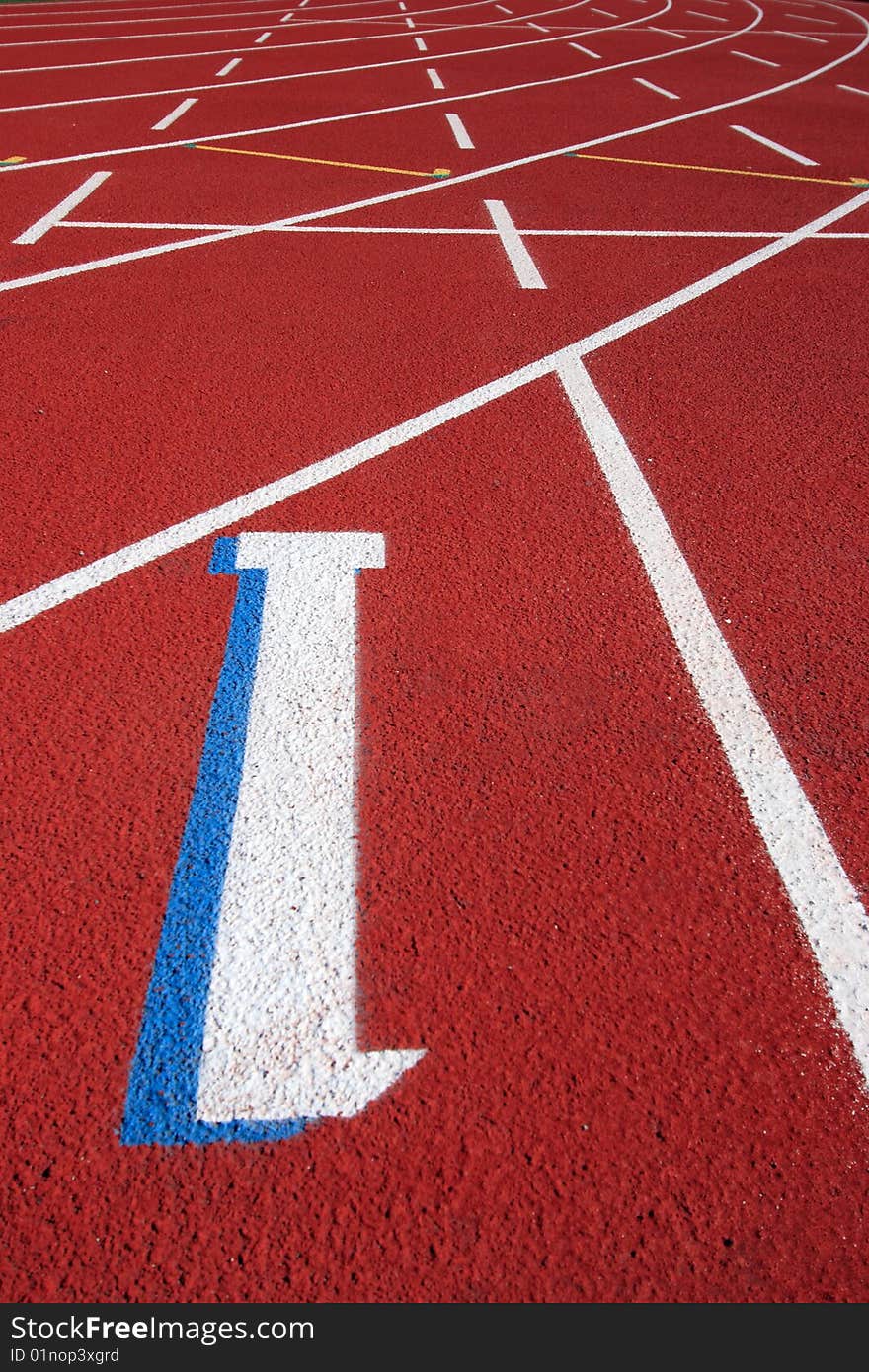 Red field track with numbers and lines in white. Red field track with numbers and lines in white.