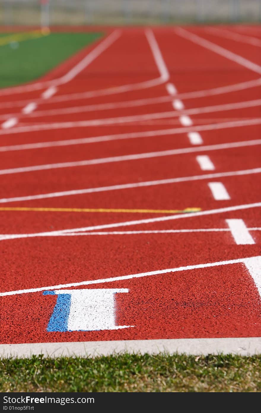 Red field track with numbers and lines in white. Red field track with numbers and lines in white.