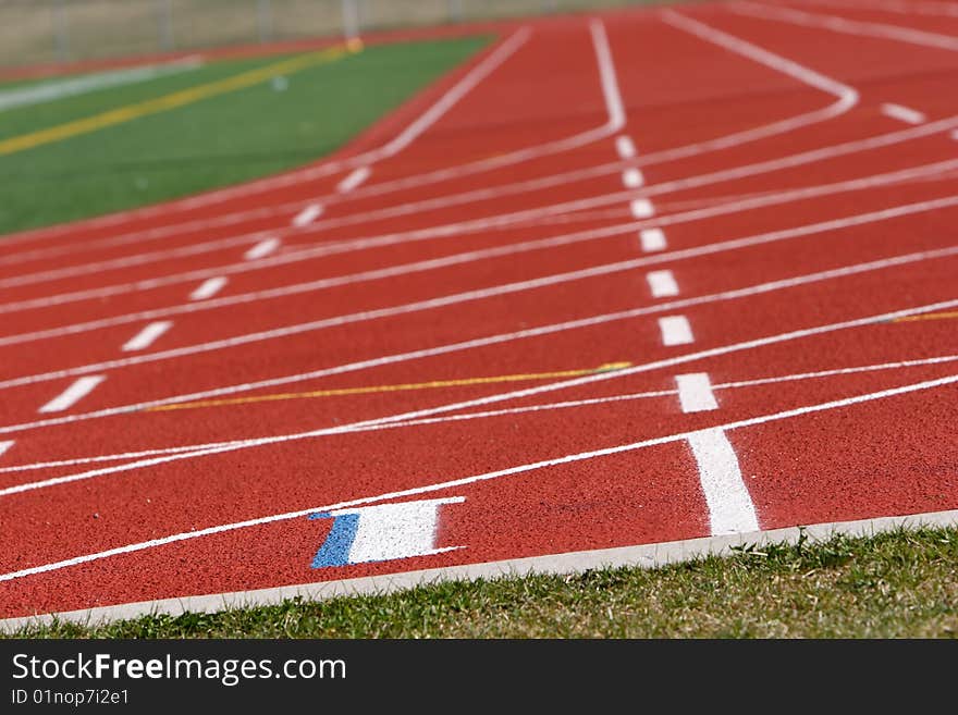 Red field track with numbers and lines in white. Red field track with numbers and lines in white.