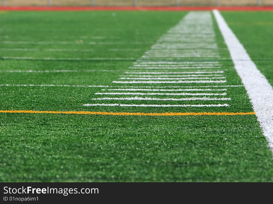 White marking lines on the side of a stadium field. White marking lines on the side of a stadium field.