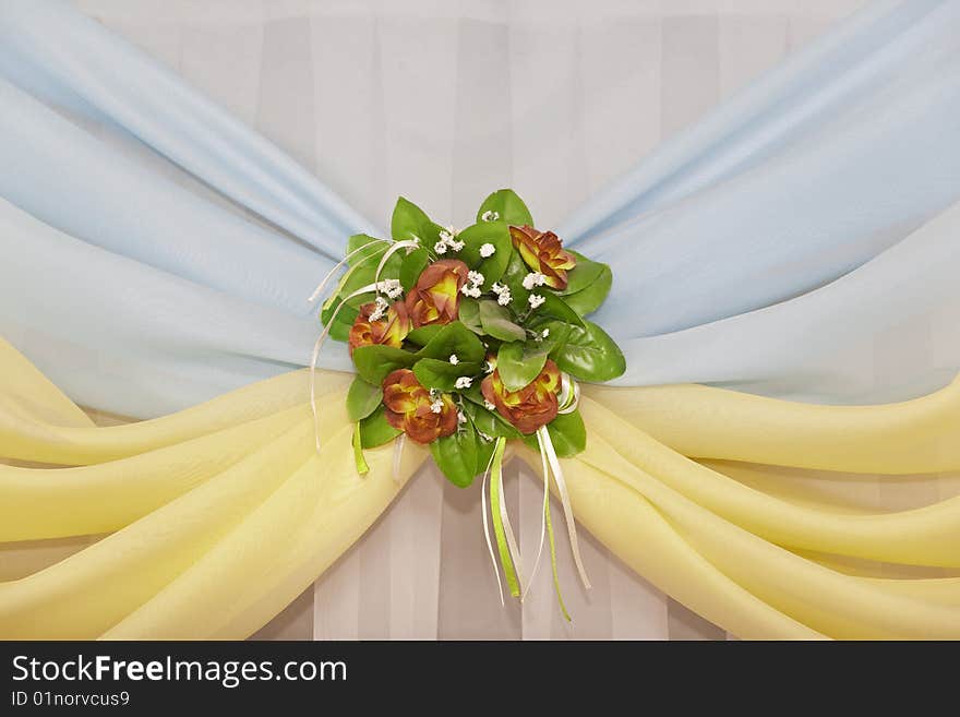 Fine curtain with a bunch of flowers at a window