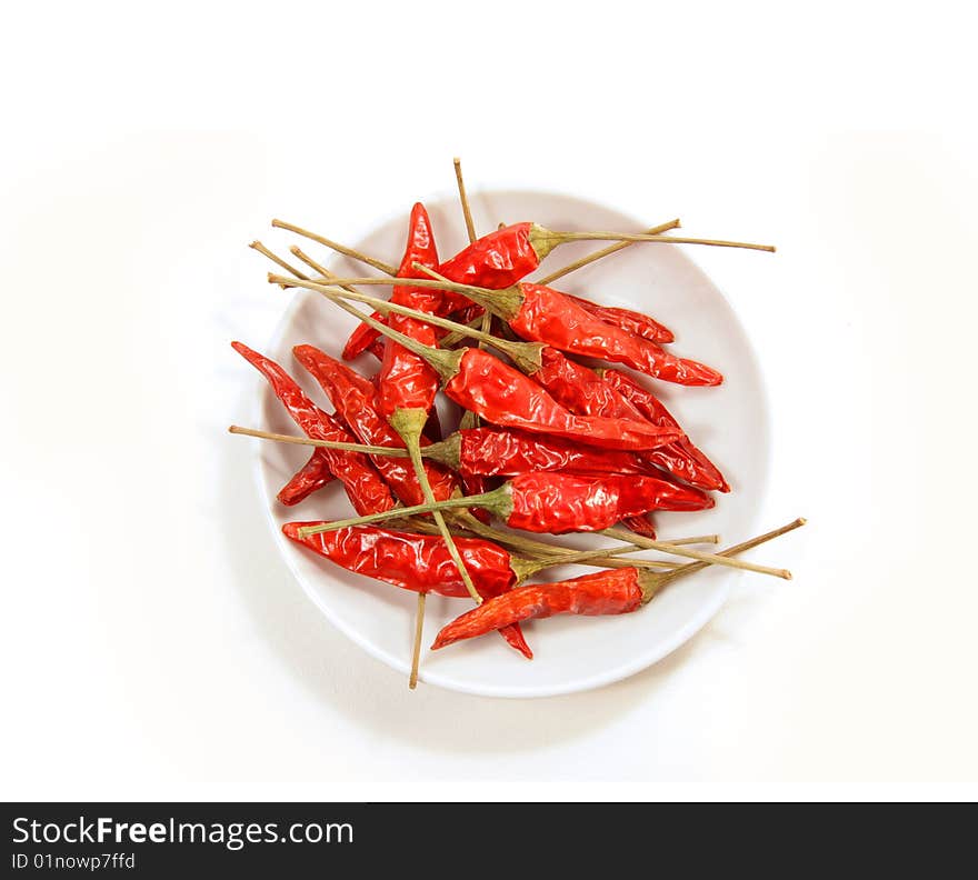 Bowl of red peppers on white background