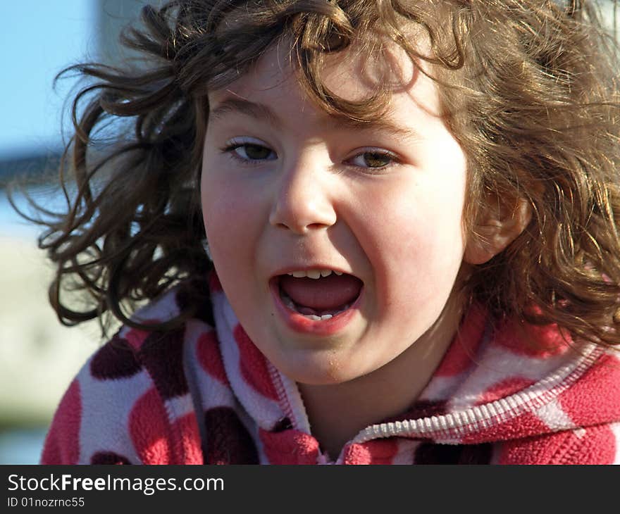 This is a sweet little girl showing an exited expression on her face. This is a sweet little girl showing an exited expression on her face.