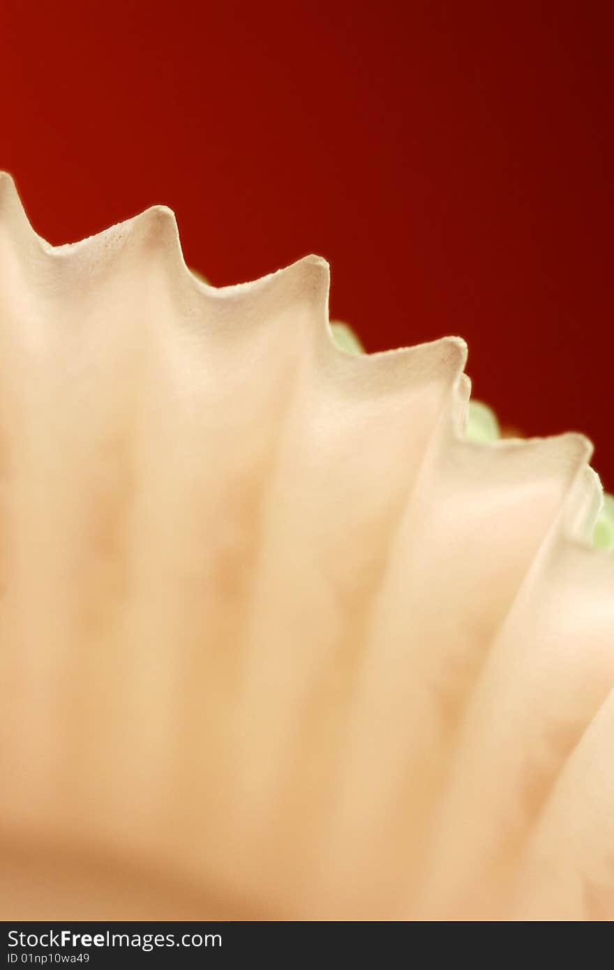 Macro of cupcake inserts against a red background