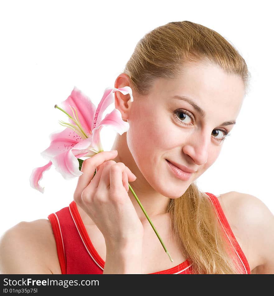 A portrait of a nice blond girl in red with a pink lily near her face on a white background. A portrait of a nice blond girl in red with a pink lily near her face on a white background