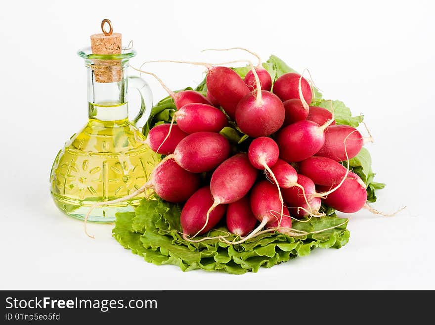 Green vegetables and a bottle of olive oil on the white background. Green vegetables and a bottle of olive oil on the white background