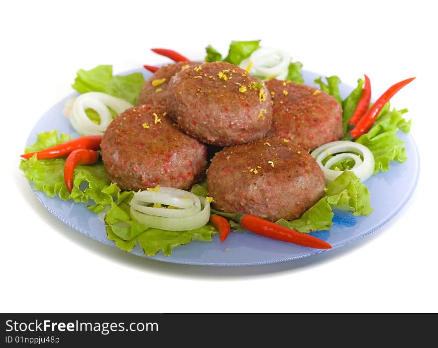 Meat rissoles with cayenne on a round plate