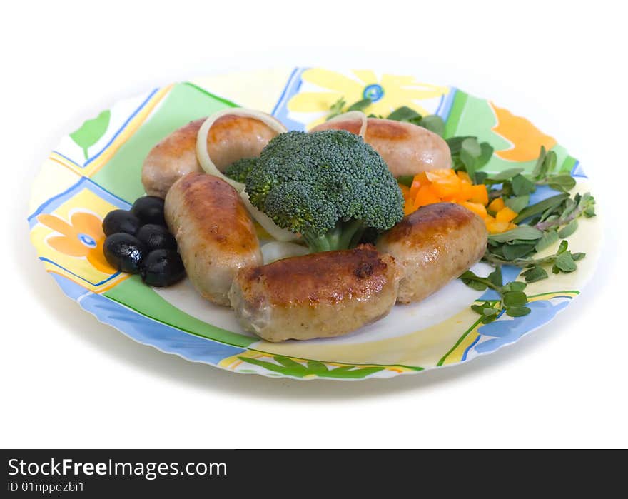 Small sausages with cauliflower and olives on a round plate