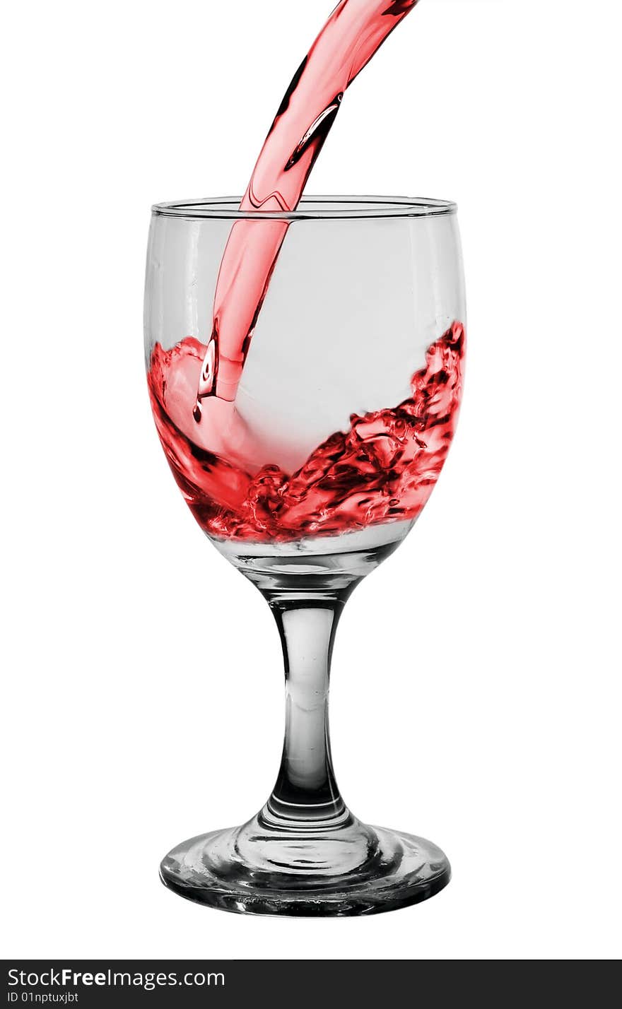 Glass with pouring red wine