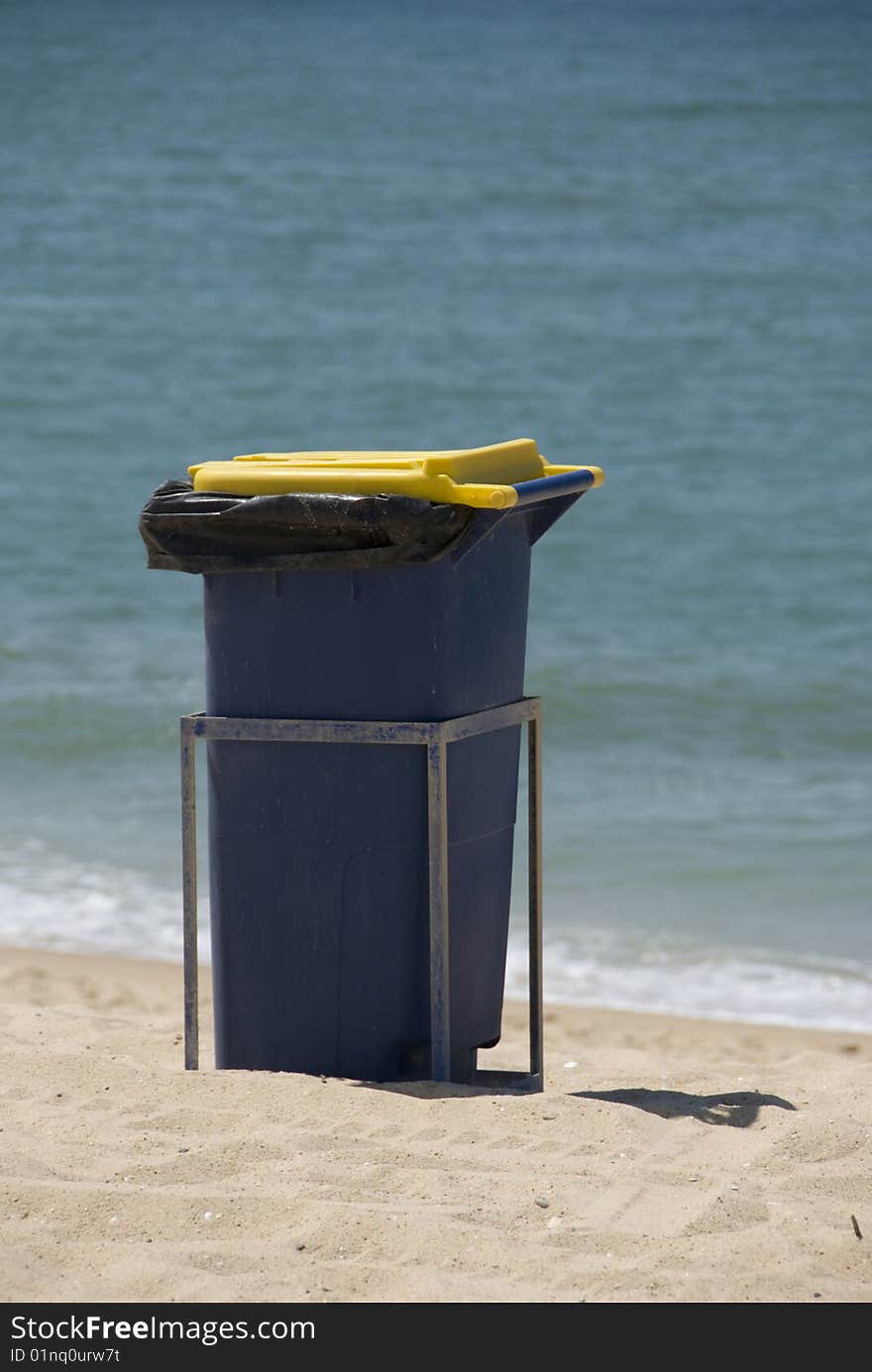 Waste bin sited on a beach for bathers to dispose of their rubbish. Waste bin sited on a beach for bathers to dispose of their rubbish