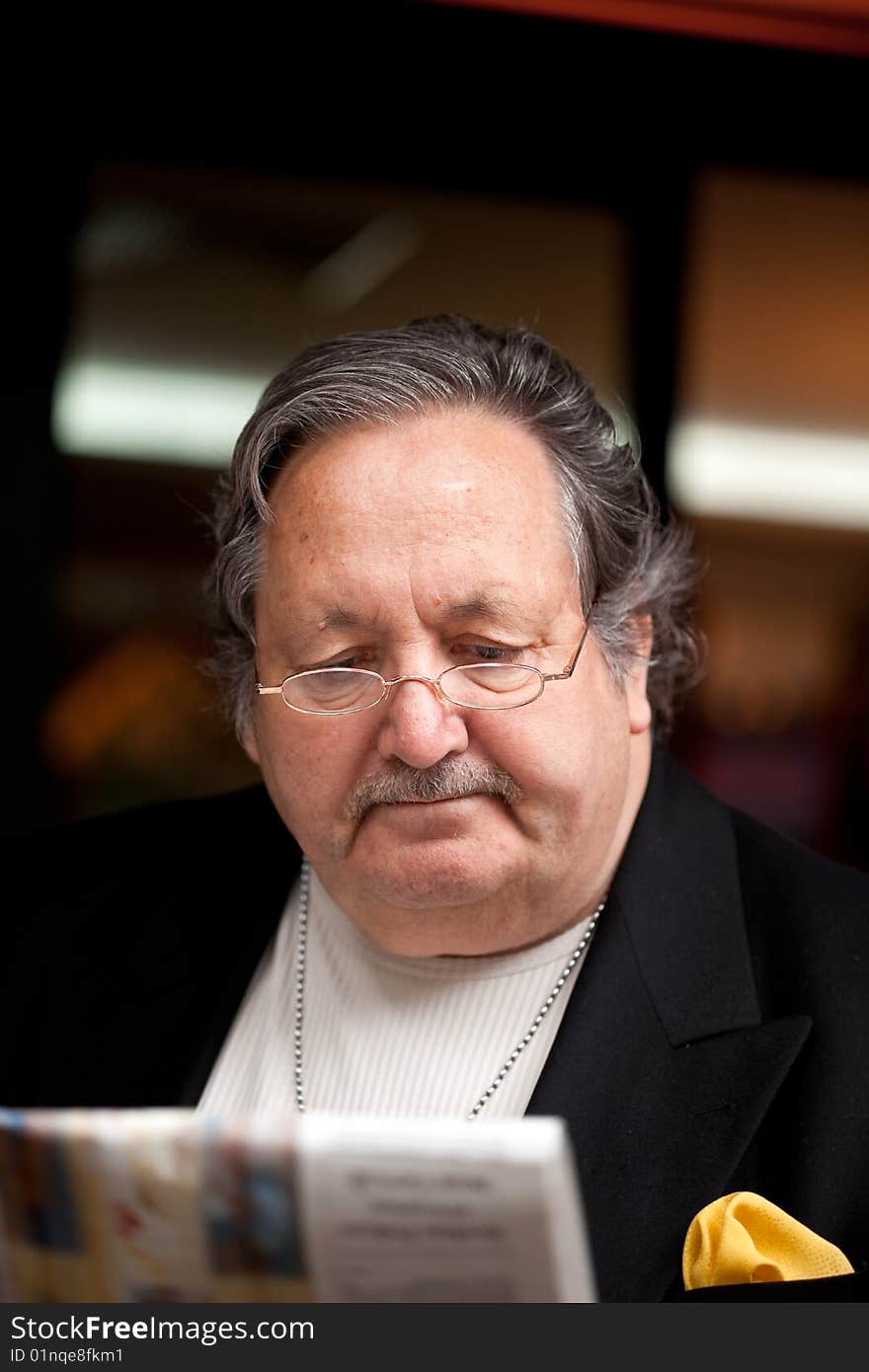 Senior man in the restaurant reading newspaper. Senior man in the restaurant reading newspaper