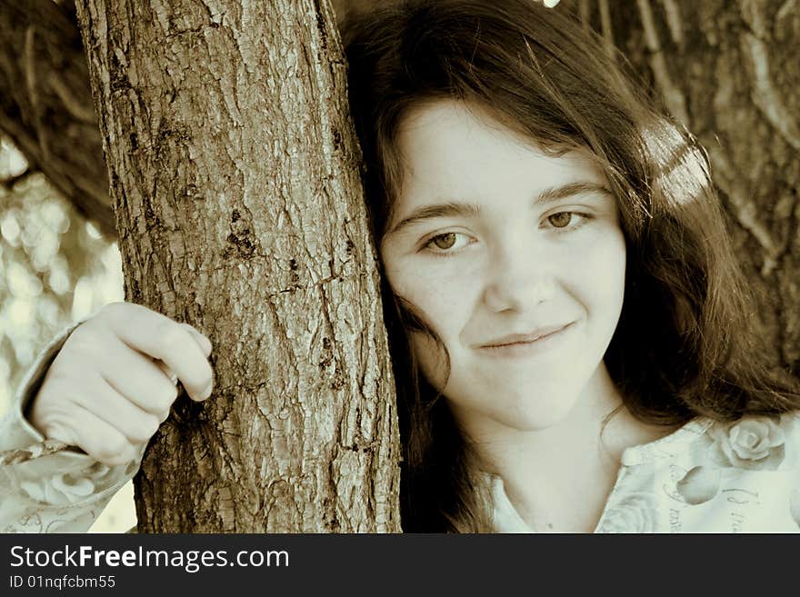 Teen girl leaning on tree beauty