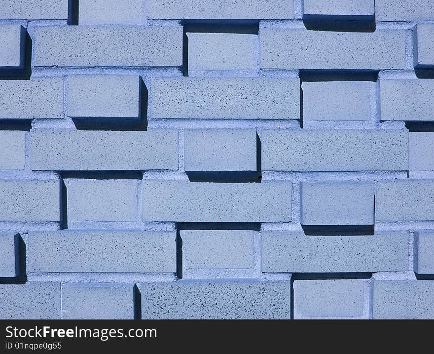 A pastel blue multi-layered and multi-sized brick wall. A pastel blue multi-layered and multi-sized brick wall.