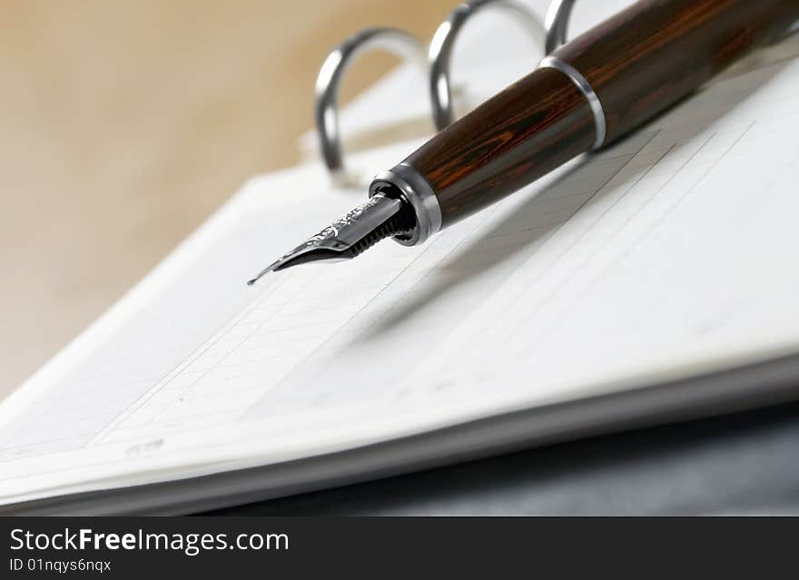 Agenda and ball pen  on a white background