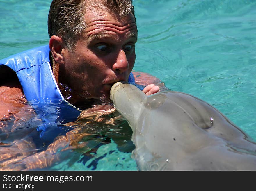 Man kissing dolphin,or dolphin kissing man