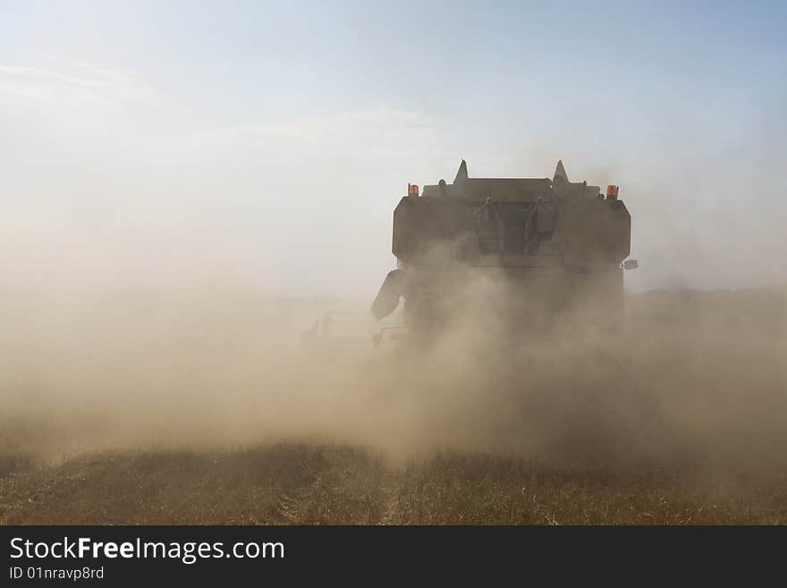 Agriculture - Combine in cloud of impurity during harvesting