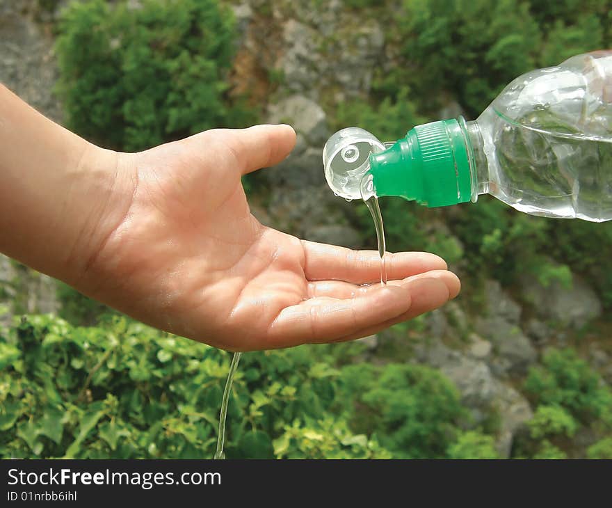 Water and hand and green tree. Water and hand and green tree