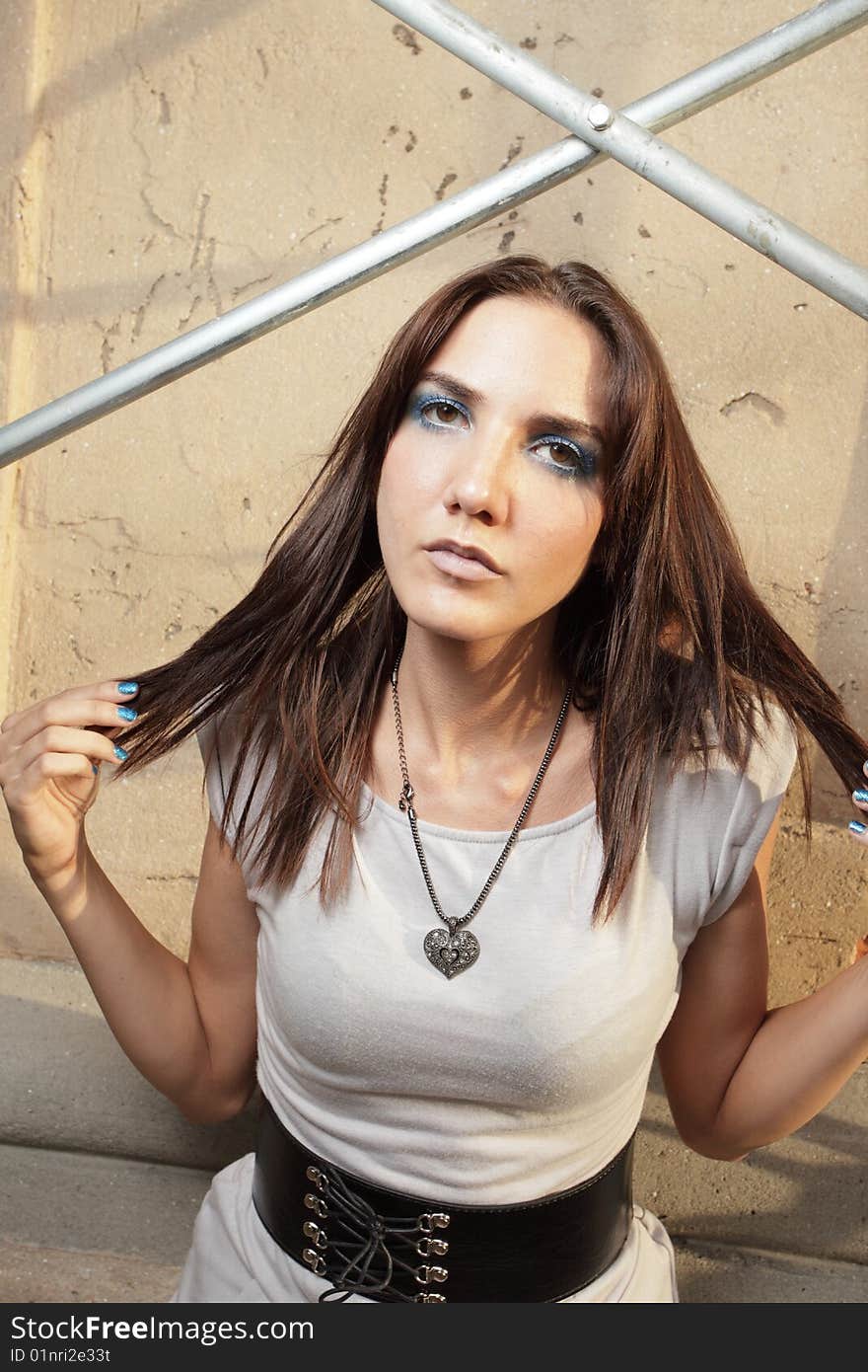 Woman posing by scaffolding