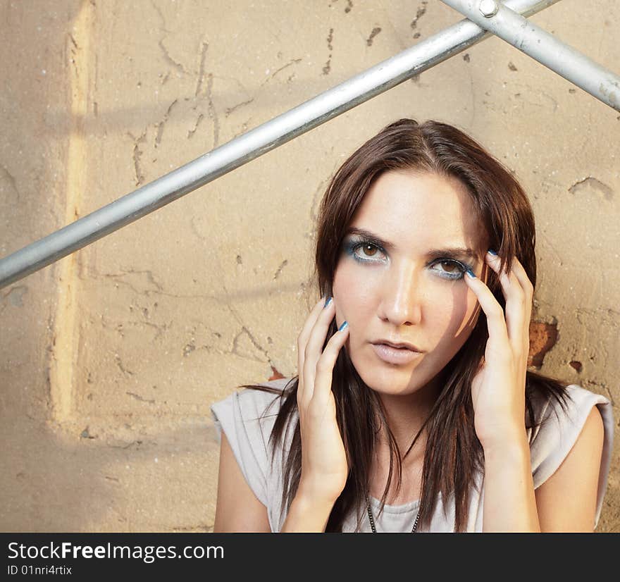 Woman posing by scaffolding