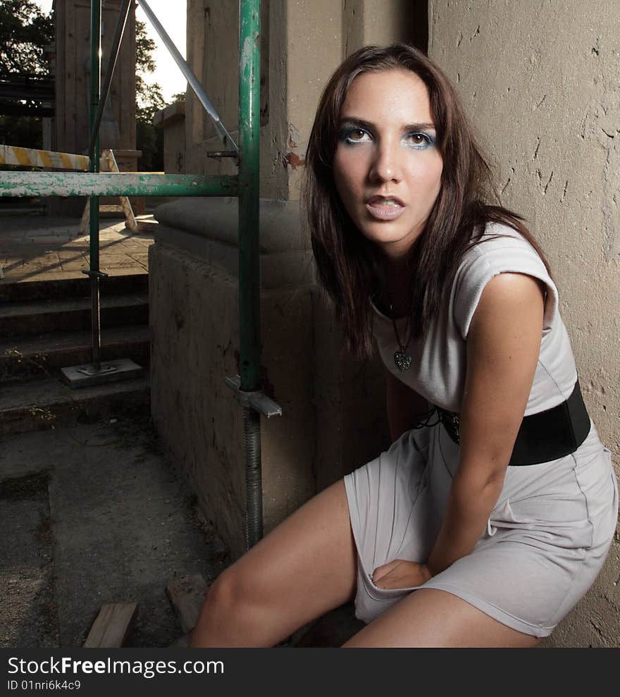 Woman posing by scaffolding