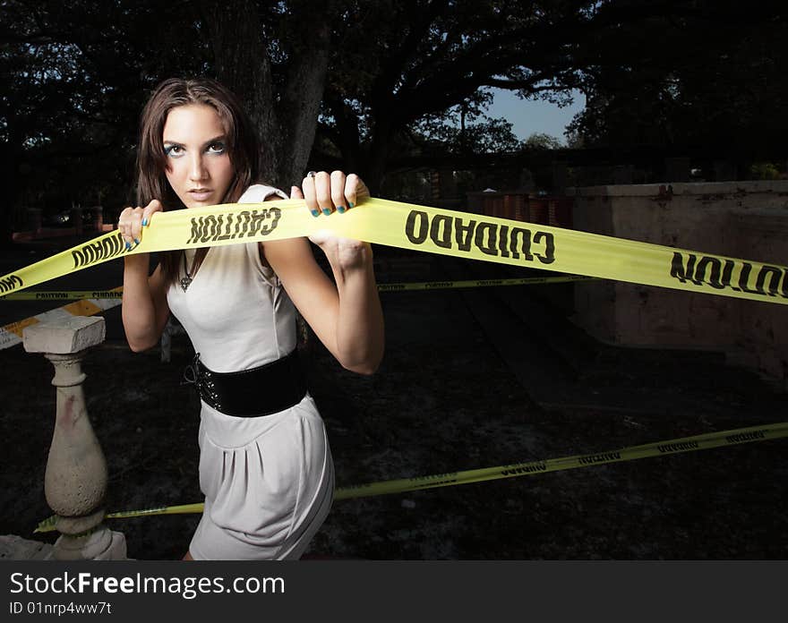 Woman pulling on caution tape