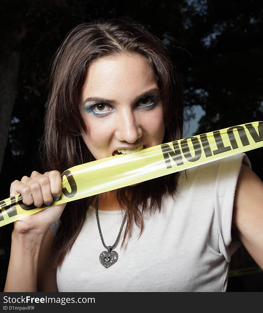 Woman Biting Caution Tape