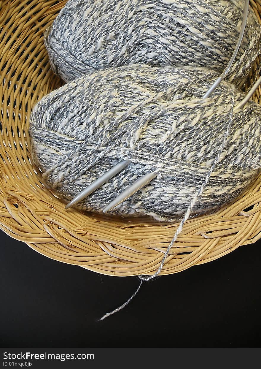 Pied threads bundles in basket, needle. Pied threads bundles in basket, needle