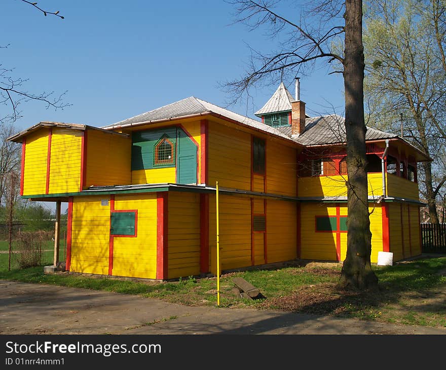 Yellow colored wooden house on river bank