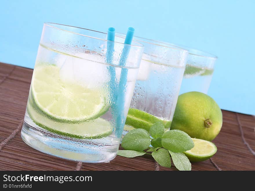 Frosty cold glass of ice water with lime