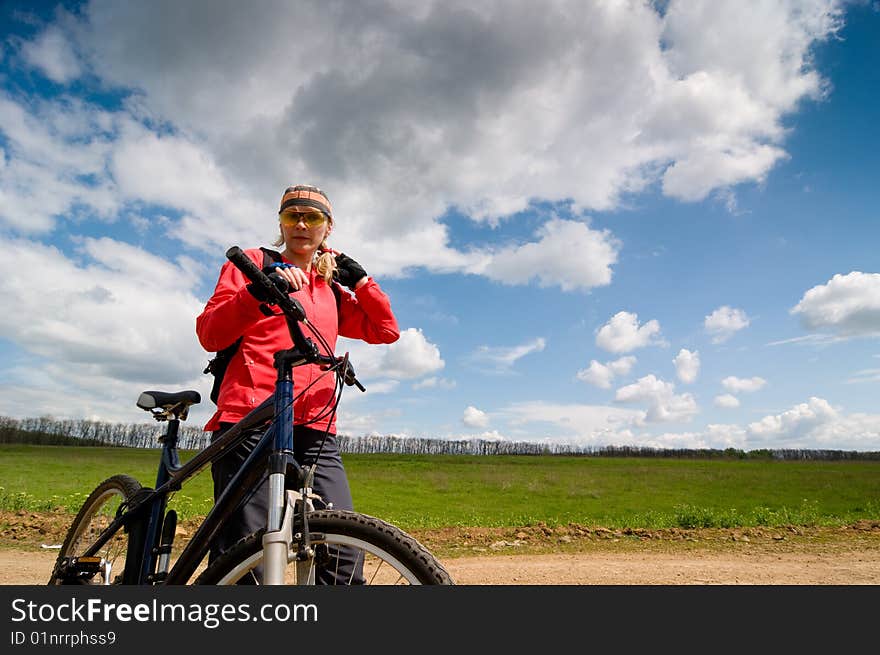 Girl with bike in green summer field. Girl with bike in green summer field