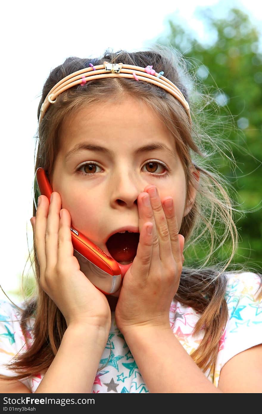 Beatiful young girl speaking on the phone. Beatiful young girl speaking on the phone