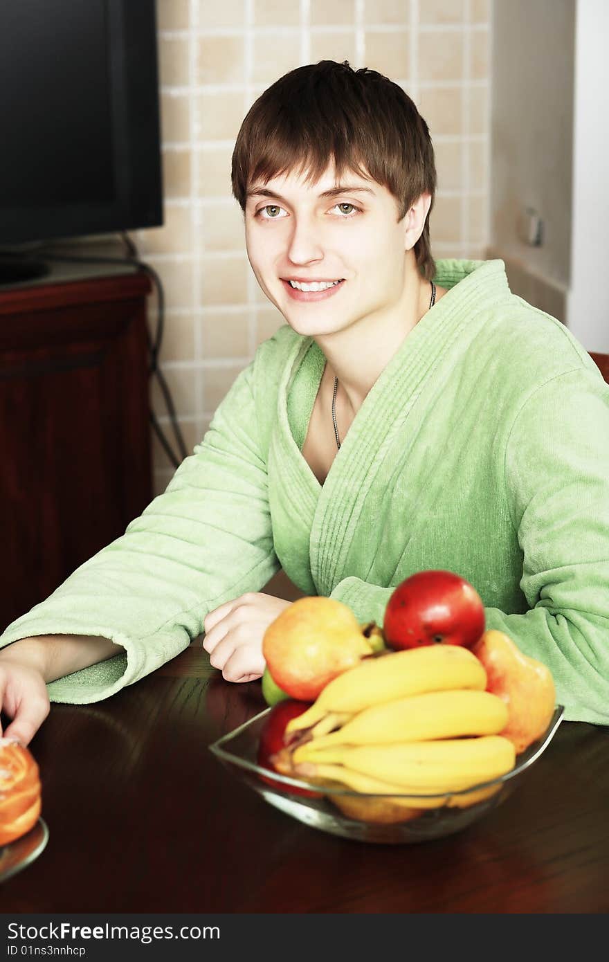 Happy young man on a kitchen at home. Happy young man on a kitchen at home.