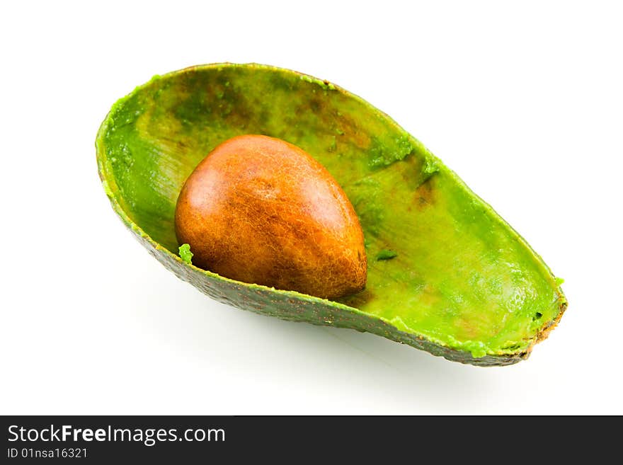 Single dark green avocado fruit split in half scooped out and showing the kernel on a white background. Single dark green avocado fruit split in half scooped out and showing the kernel on a white background