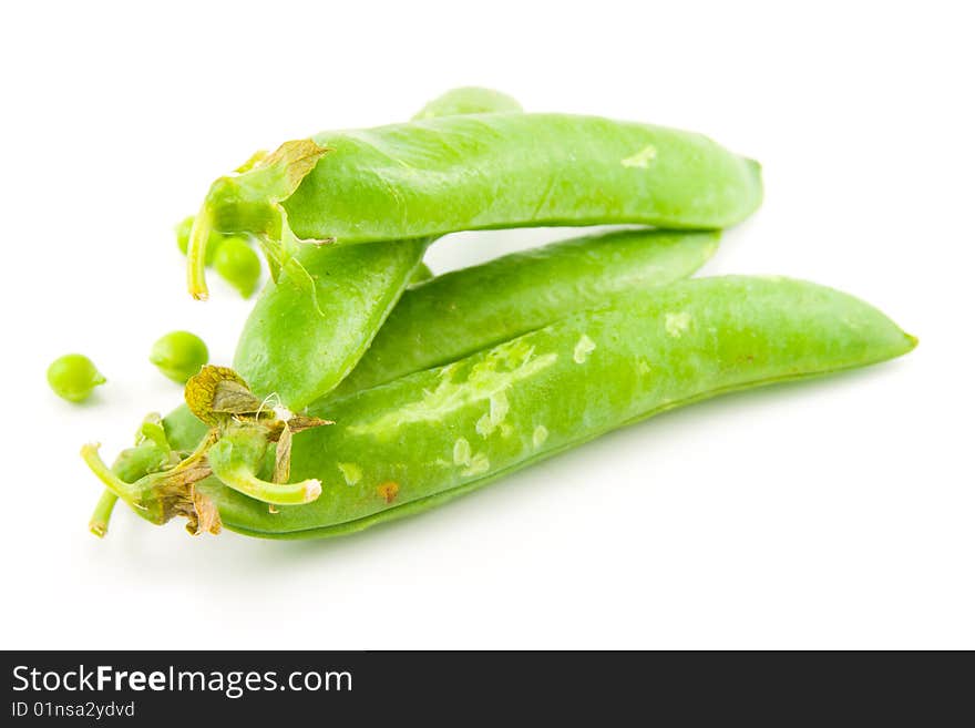 Four whole ripe peapods or english peas containing peas on a white background