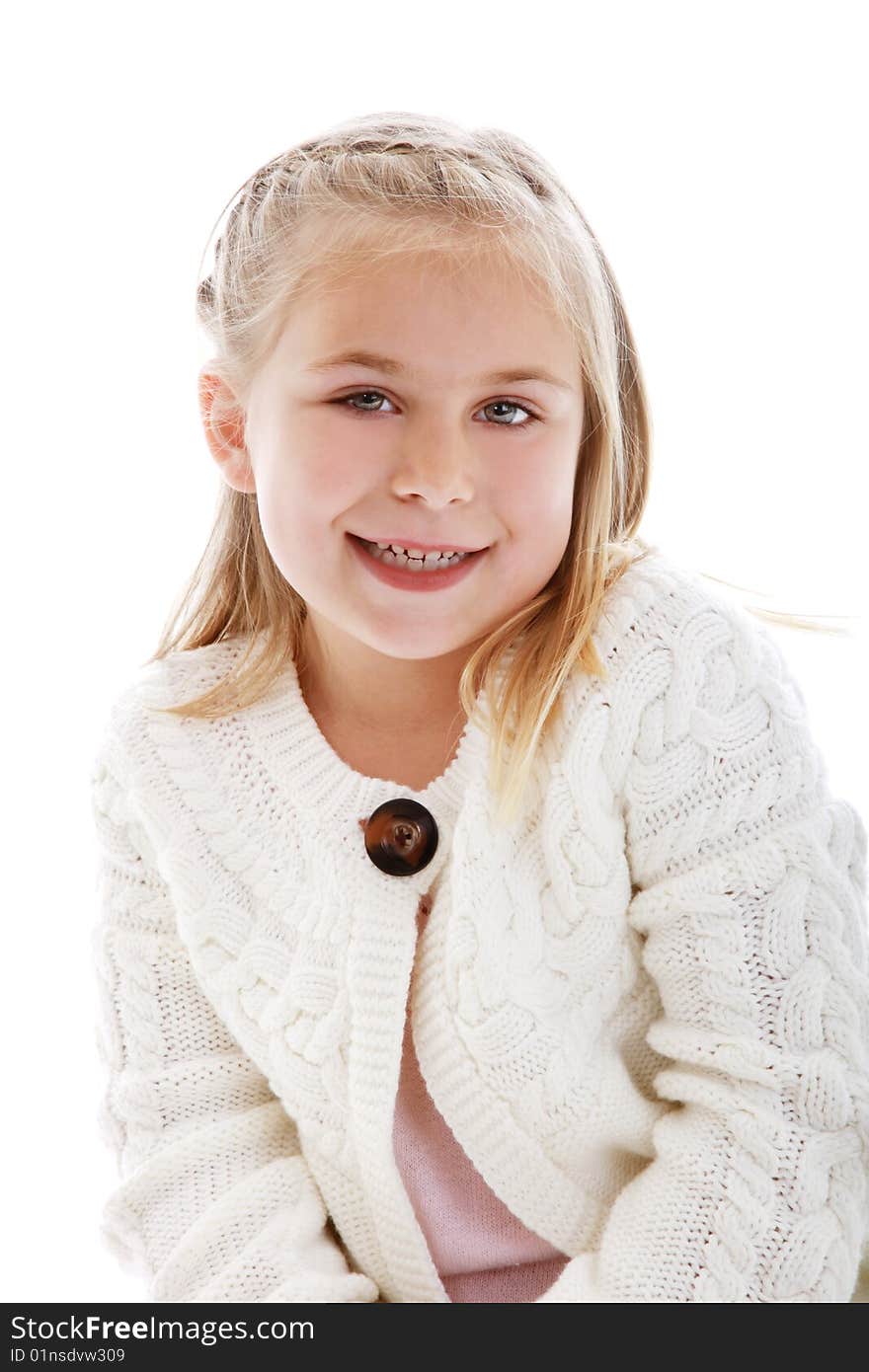 Cute little girl wearing a white sweater.