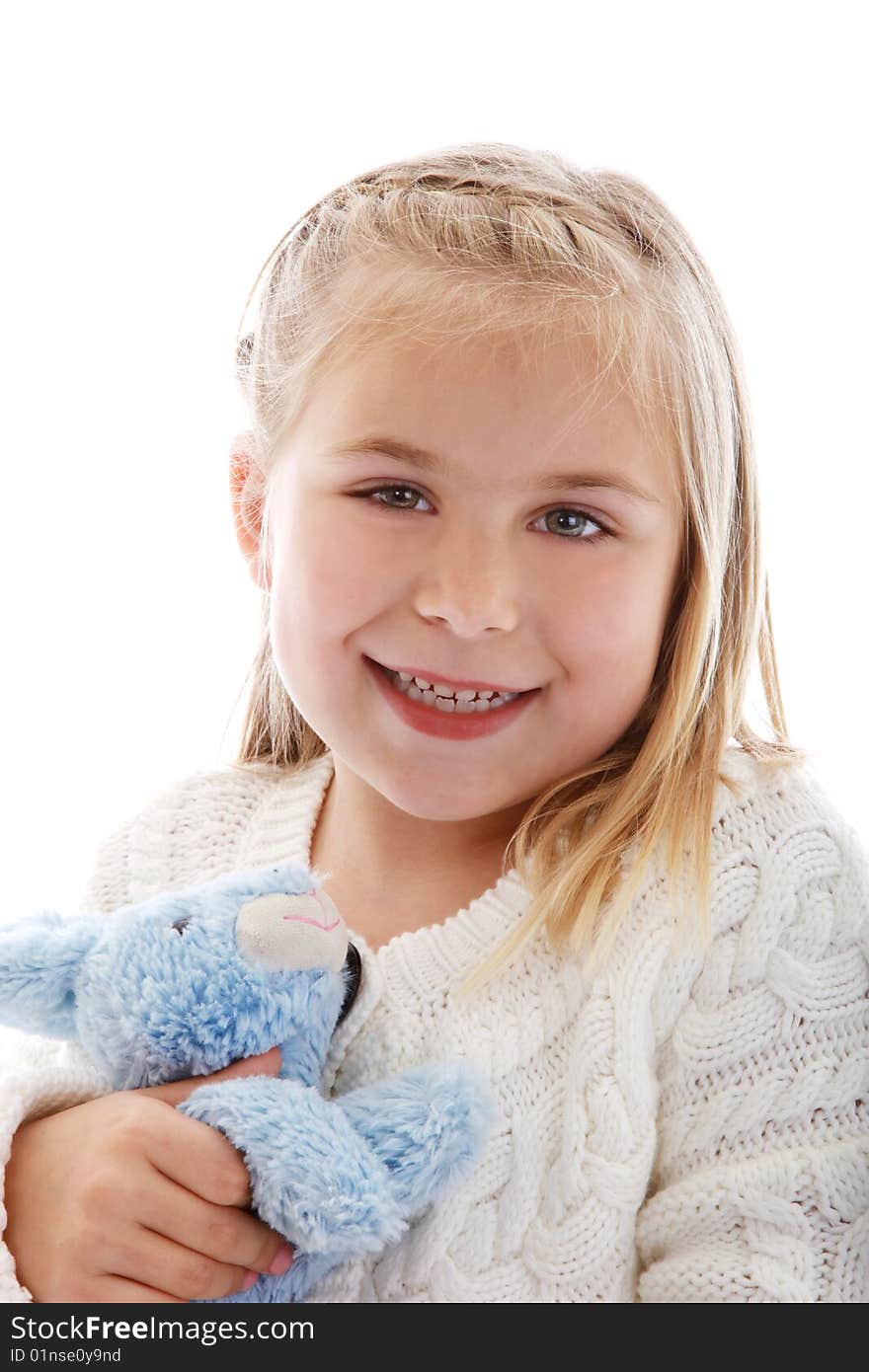 Cute little girl wearing a white sweater.