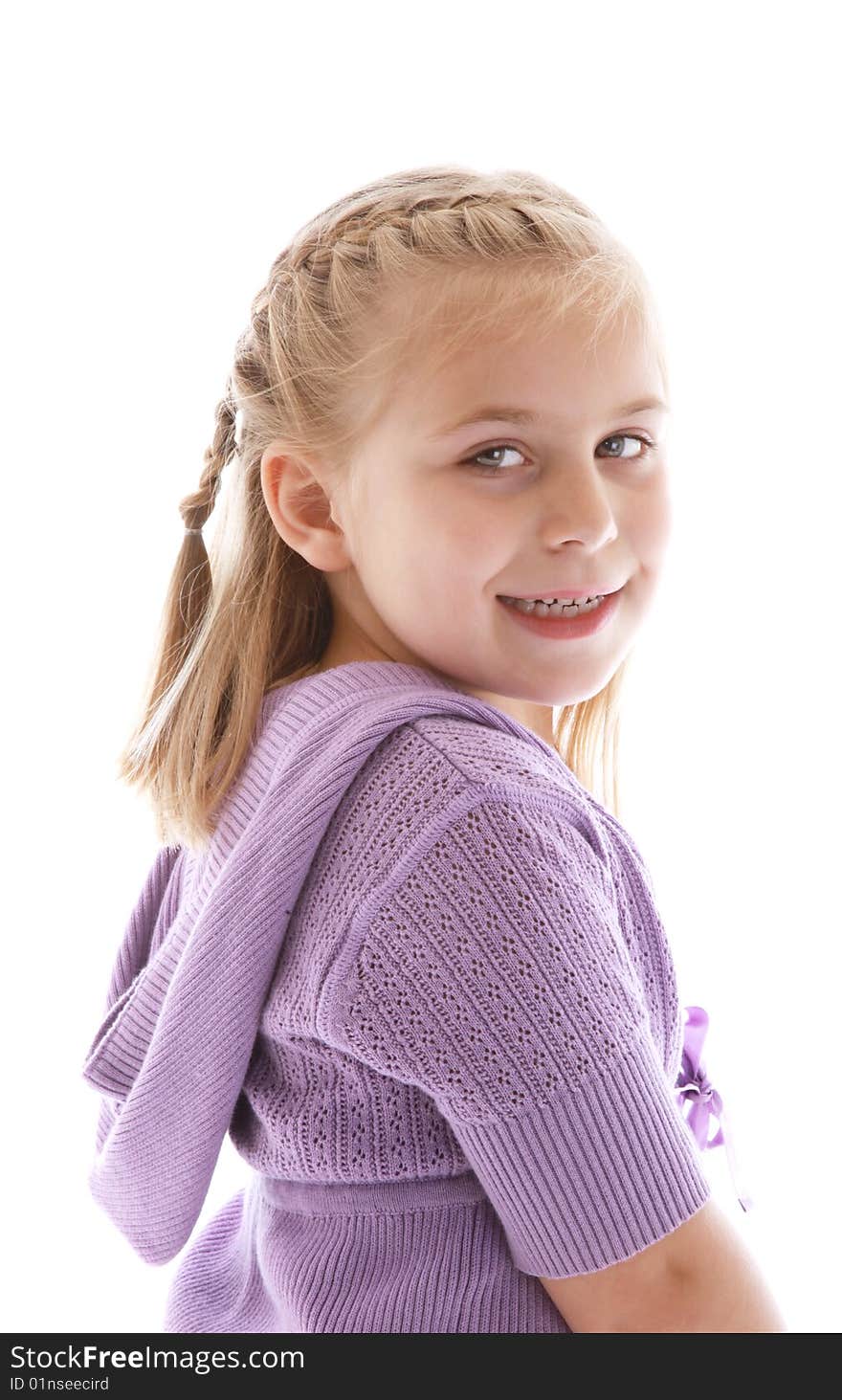 Cute little girl wearing a purple sweater.